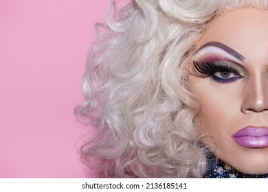 cropped view of man in bright makeup and wig isolated on pink