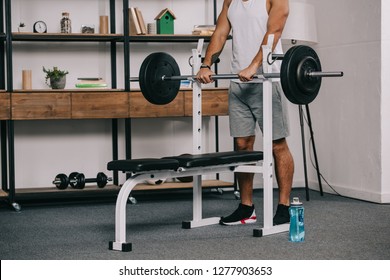 Cropped View Of Man Exercising In Home Gym 