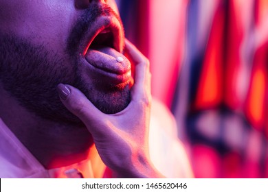 Cropped View Of Man With LSD On Tongue And Woman Touching His Face 