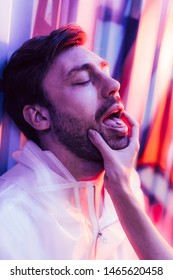 Cropped View Of Man With LSD On Tongue And Woman Touching His Face 