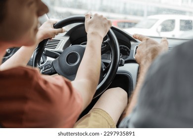 cropped view of man pointing away with finger while teenage son driving car - Powered by Shutterstock