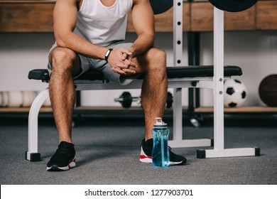 Cropped View Of Man Sitting With Fitness Watch Near Sport Bottle 
