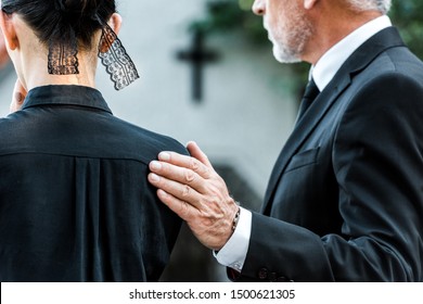 cropped view of man touching woman on funeral  - Shutterstock ID 1500621305