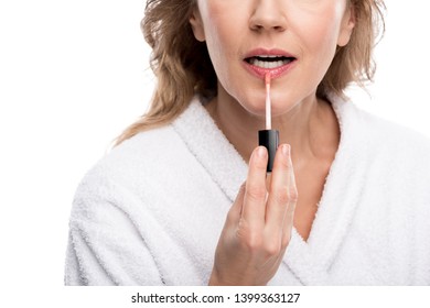 Cropped View Of Mature Woman Applying Lip Gloss Isolated On White 