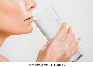 Cropped View Of Mature Woman Drinking Water From Glass Isolated On Grey 