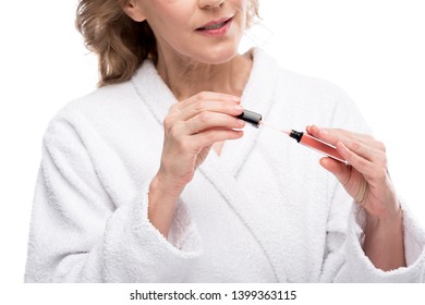 Cropped View Of Mature Woman Holding Lip Gloss Isolated On White 