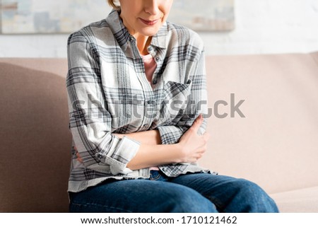 Similar – Young female sitting by table and making clay or ceramic mug in her working studio