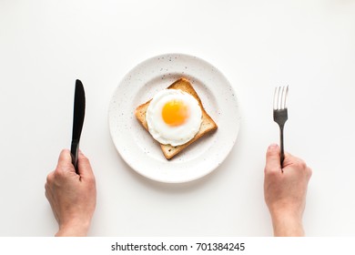 Cropped View Of Person Eating Breakfast With Fried Egg On Toast, Isolated On White