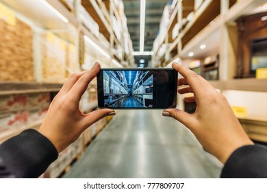 Cropped View Of Person Taking Photo Of Shipping Stock On Smartphone, Camera Point Of View