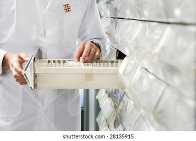 Cropped View Of Pharmacist Taking Medicine From Drawer. Copy Space