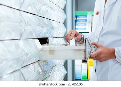 Cropped View Of Pharmacist Taking Medicine From Drawer. Copy Space