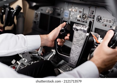 Cropped View Of Pilot Using Yoke In Airplane