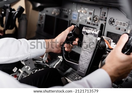 cropped view of pilot using yoke in airplane