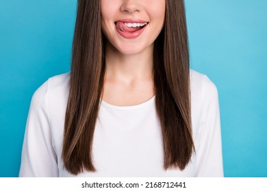 Cropped View Portrait Of Attractive Cheerful Funny Girl Licking Lips Tasty Balm Lipstick Isolated Over Bright Blue Color Background