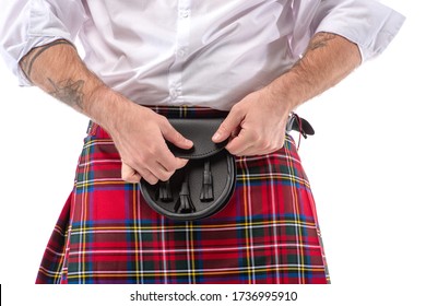 Cropped View Of Scottish Man In Red Kilt Touching Leather Belt Bag Isolated On White