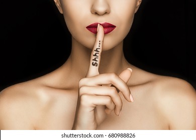 Cropped View Of Seductive Woman With Red Lips Showing Shh Symbol, Isolated On Black  