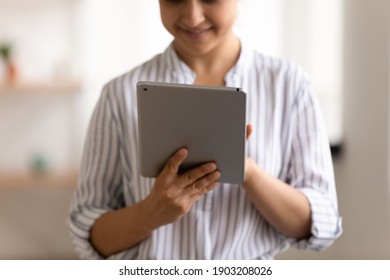 Cropped View Of Smiling Female User Holding New Model Of Electronic Tablet Computer Scrolling Data On Wide Touchscreen. Happy Young Woman Navigating Internet Using Modern Gadget Digital Pad. Close Up