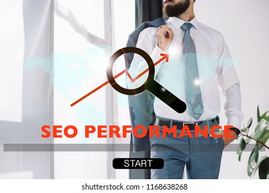 cropped view of successful developer standing near window with SEO performance