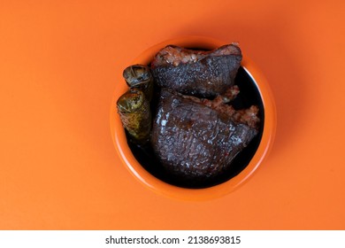 Cropped view of traditional delicious stuffed stuffed and olive oil wrap, shot from overhead angle with selective focus on blue background, in isolated setting.