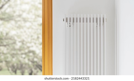 Cropped View Of White Stylish Radiator In Contemporary Living Room Interior Design. Central Heating Installation. Warm Home. Room Heater With Temperature Controller