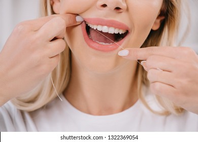 Cropped View Of Woman Flossing Teeth With Dental Floss