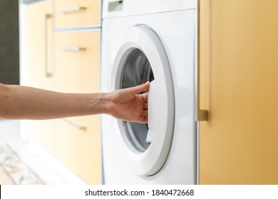 Cropped View Of Woman Hand Open Or Closed Door At Modern Washing Machine. Housewife Doing Laundry At Home And Using Washhouse Equipment