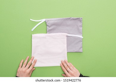 cropped view woman hands and eco friendly bags isolated on green - Shutterstock ID 1519422776