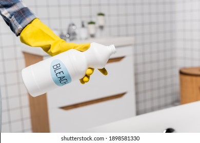 Cropped View Of Woman Holding Bottle With Bleach Lettering In Bathroom