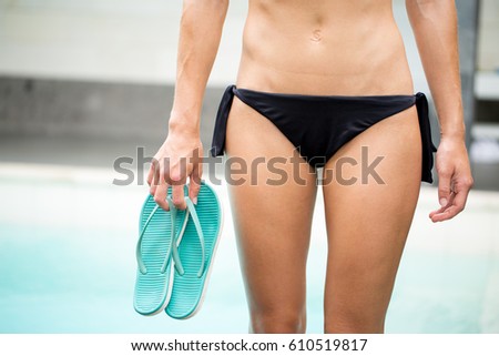 Cropped View of Woman Holding Flip-Flops