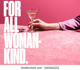 cropped view of woman holding glass of rose wine on velour cloth isolated on pink, for all woman kind illustration