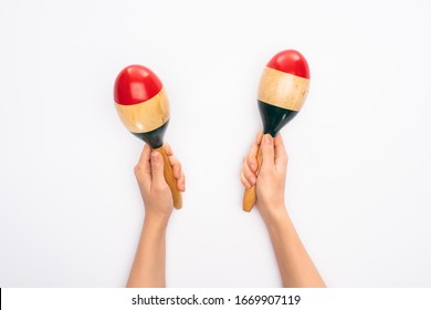 Cropped view of woman holding maracas on white background