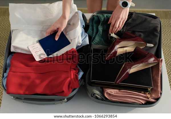 packing clothes in suitcase