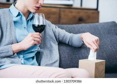 Cropped View Of Woman Sitting With Glass Of Red Wine And Tissue Box At Home