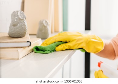 Cropped View Of Woman In Yellow Rubber Glove Cleaning Book Shelf