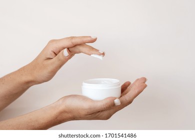 Cropped View Of Young Adult Girl Holding Container With Bodycare And Skincare Cream In Hands. Organic Cosmetics Product Isolated On White Background With Copy Space