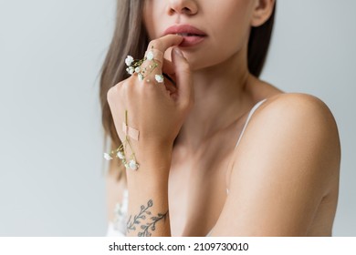 Cropped View Of Young Woman With Tiny Flowers On Tattooed Hand Isolated On Grey