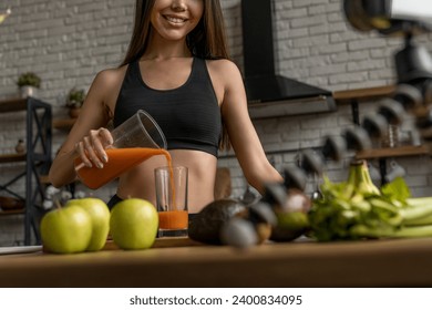 Cropped of young lady in sports wear preparing healthy juice while recording live stream for her followers about sporty living, healthy eating, detoxication and veganism - Powered by Shutterstock