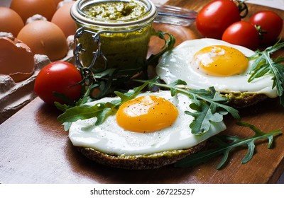 Croque-madame With Fried Egg , Pesto Sauce And Rucola.
Close Up. Traditional French Toasted Sandwich