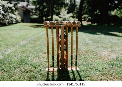 A croquet set in a nicely mowed yard.