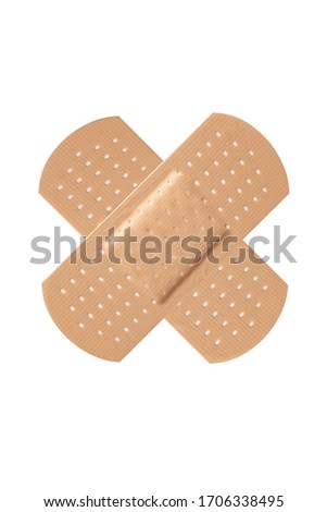 Cross adhesive bandage plaster on white background.