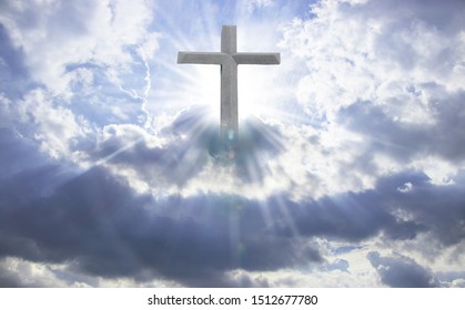 A cross with a blue sky shining from the sun. Abstract concept. - Shutterstock ID 1512677780