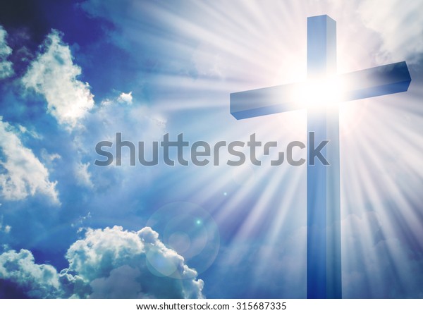 十字架与明亮的阳光和云彩的背景库存照片 立即编辑