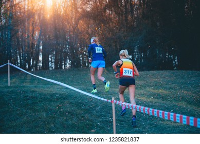 Cross Country Race. Professional Female Athlete Running Together In Trail Nature