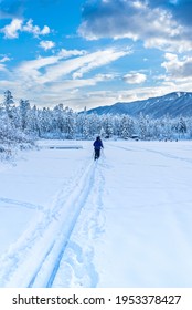 Cross Country Skiers on a newly frozen Lake Lillian near Invermere, BC, Canada