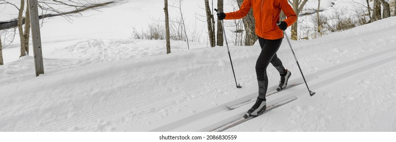 Cross Country Skiing Classic Style Nordic Skiing In Forest. Unrecognizable Woman In Winter Doing Winter Sport Activity In The Snow On Cross Country Ski In Nature. Banner Showing Skis, Boots And Poles.