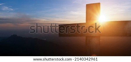 Cross crucifixion of jesus - Wooden cross at sunset sky background. Crucifixion and resurrection concept.