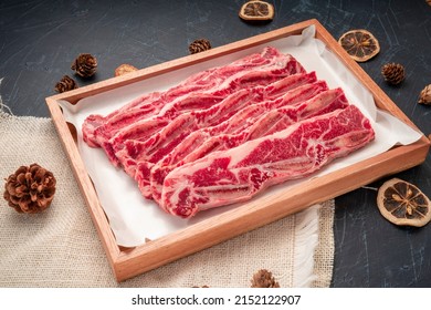 Cross Cut Short Ribs beef on wooden plate, Beef Short Ribs (Sliced) on wooden background.