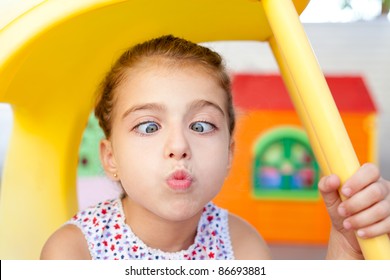 Cross Eyed Squinting Expression Little Girl In Playground