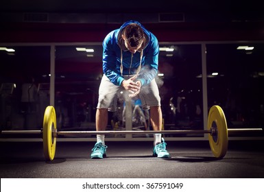 Cross fit weightlifter preparing for training. Shallow depth of field, selective focus on hands and dust. - Shutterstock ID 367591049