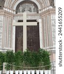 A cross in front of the main portal at Easter, Bologna, Italy